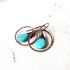 "Two genuine faceted turquoise semi precious teardrop shaped stones are dangled inside a hand hammered copper circle. They measure 1 1/4\" from the top of the copper earwire and measure 3/4\" wide. Very Lightweight and comfortable for all day wear. All my jewelry comes in a box with a decorative ribbon ready for gift giving whether it is a gift for you or someone special. See more of my jewelry designs here: https://www.etsy.com/shop/JensBeadBox Thank you for visiting Jen's Bead Box Jewelry!" Genuine Turquoise Jewelry, Beaded Boxes, Semi Precious Stone, Hammered Copper, Box Jewelry, Genuine Turquoise, Natural Turquoise, Turquoise Earrings, Turquoise Jewelry