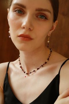 Indulge in the exquisite allure of this gemstone necklace. Handmade with precision, it showcases a captivating blend of dark red and purple gemstones, intertwined with lustrous freshwater pearls. Each bead is meticulously chosen, creating a harmonious symphony of colors.