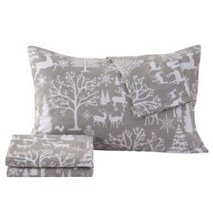 a bed with two pillows and a pillow case in grey, white and gray reindeer print