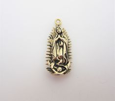 "-14kt yellow gold -Hand cast, polished and antiqued -3-D -Perfect for charm bracelets and pendant necklaces -Detailed, intricate design featuring New Mexico landmarks -14kt jump ring included on most charms (not in photos) -Made in New Mexico, USA -Our lady of Guadalupe is widely worshiped in Mexico and New Mexico. The Virgin of Guadalupe holds special significance in the history and culture of New Mexico such as at The Santuario de Guadalupe, the oldest church in the United States honoring the Gold Antique Finish Jewelry For Commemoration, Antique Finish Gold Jewelry For Commemoration, Traditional Gold Jewelry For Commemoration, 14k Gold Spiritual Miraculous Medal Jewelry And Charms, 14k Gold Spiritual Miraculous Medal Jewelry, Gold Spiritual Jewelry And Charms For Wedding, Gold Spiritual Charms And Jewelry, Gold Jewelry With Antique Finish For Collectors, Spiritual Yellow Gold Our Lady Of Guadalupe Jewelry