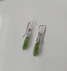 Drop shape Canadian Jade delicate earrings. Genuine nephrite stone earrings. Delicate short green stone earrings. Nice quality natural Canadian Jade from B.C. and sterling silver. Total length with closer is 3,5 cm. Each pair comes with security backings and a nice little bag ready for gift. Teardrop Jade Earrings With Natural Stones, Minimalist Green Teardrop Earrings, Green Jade Earrings With Natural Stones, Green Drop Earrings, Pierced, Green Pierced Drop Earrings, Green Minimalist Dangle Earrings, Green Minimalist Pierced Earrings, Minimalist Green Pierced Earrings, Green Stone Earrings