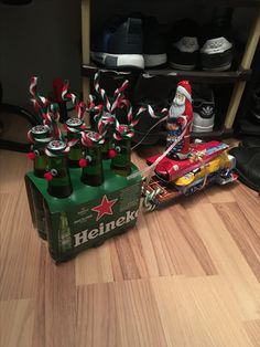 a bunch of beer bottles sitting on top of a wooden floor next to a shoe rack