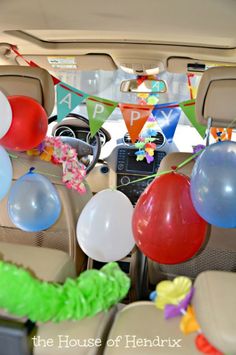 balloons and streamers in the back of a car