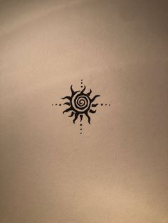 a black and white photo of a sun tattoo