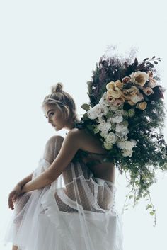 a woman with flowers in her hair and dress