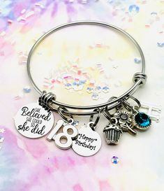 A handmade 18th birthday teen girl gift, with her initial and birthstone to make it extra special. A unique and personalized gift! This initial bracelet will arrive with the following charms, the "She believed she could so she did" charm, the #18 charm, the "Happy Birthday" charm, flower charm, and the initial and birthstone of your choice. You will be asked to select the initial and birthstone you need during the checkout process. Custom jewelry and handmade gifts are the perfect teen daughter Personalized Bracelet For Birthday Gift, Customized Bracelets For Birthday, Personalized Birthday Bracelets As Gifts, Personalized May Birthstone Bracelets For Birthday, Hand Stamped Bracelets For Birthday And Mother's Day, Adjustable Hand Stamped Jewelry For Birthday, Gift For 18th Birthday, Gifts For 18th Birthday, Birthday Charm Bracelet