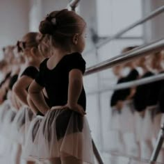 young ballerinas in black and white tutus lined up at the ballet school