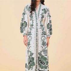 Bring Your Wardrobe To Life With The Forest Soul Off-White Maxi Dress From Farm Rio. This Fit-To-Flare Style Showcases A Stand-Up Collar, A Flattering V Neckline With Scalloped Edge, Long Balloon Sleeves With Buttons At The Cuff, And Central Buttons. This Dress Cinches Slightly At The Waist Before Falling Into A Full Skirt, Perfect For Both Day And Night Time Looks. The Finishing Touch Is The Contrasting Green Floral Patterns That Cover The Dress. Panama Fashion, Long Sleeve White Midi Dress, Sustainable Dress, Rio Brazil, Soul Shine, Printed Dresses, Floral Print Midi Dress, Maxi Shirt Dress, Linen Maxi Dress