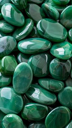 many green stones are stacked together on top of each other in this close up photo