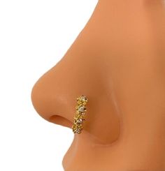 a close up view of the side of a woman's nose with a ring on it