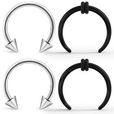 three pairs of black and silver captive rings with metal spikes on each side, one has an