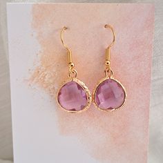 Gold Earrings Purple  Earrings Bridesmaid Earrings Amethyst Drop Earrings Pink Faceted Drop Earrings on Stainless Steel Hypoallergenic Earwires These Gold Earrings are beautiful  Amethyst colour Faceted Glass set in Gold Plate with Stainless Steel, gold plate Earwires *They are a slightly darker purple than they appear in the photos Simple, effective and a classical pair of earrings The Earwires are great for sensitive ears  🌟Perfect for Bridesmaids ☀️ All Jewelery is gift wrapped 💗Please read Earrings Purple, Earrings Bridesmaid, Purple Earrings, Amethyst Color, Earrings Pink, Faceted Glass, Bridesmaid Earrings, Glass Set, Favorite Jewelry