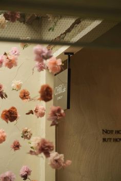 pink and red flowers hanging from the ceiling