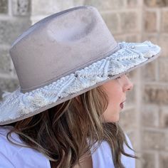 Bohemian and festive fedora hat made of eco- suede and decorated with macrame weave. Has an elastic band on the rim so it fits comfortably size medium to large. Crown: 4.5 inches (12 cm) Brim: 3 ⅜ inches (8.5 cm) Medium/Large: 57 - 59 cm. Bootsologie is NOT liable for any products damaged or lost during shipping. If you received your order damaged, please contact the shipment carrier to file a claim. Please save all packaging material and damaged goods before filing a claim. Bohemian Beige Hats For Outdoor, Bohemian Beige Hat For Outdoor, Adjustable Flat Brim Hat With Fringe, Adjustable Fringe Hat With Curved Brim, Casual Fedora Hat With Fringe, Casual Hats With Fringe And Curved Brim, White Bohemian Hat For Outdoor, Spring Flat Brim Hat With Fringe, Bohemian White Hat For Outdoor