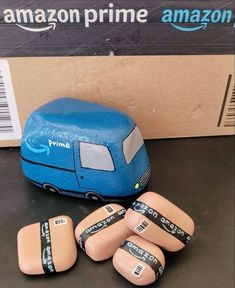 five small wooden toys sitting next to an amazon prime box with the words prime written on them