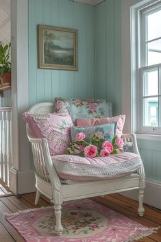 a white chair with pink flowers on it in front of a window