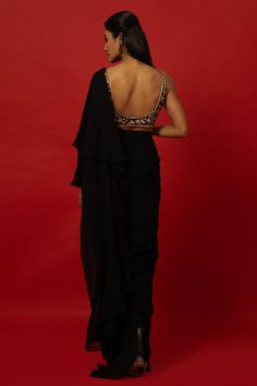 This elegant Black Ruffle Saree features a unique hand-embroidered stitched blouse for a one-of-a-kind look. The carefully crafted details add a touch of sophistication and style to any occasion. Perfect for those looking to make a statement with their traditional attire. Embroidered Georgette Pre-draped Saree For Formal Occasions, Elegant Pre-draped Saree With Floral Embroidery, Embroidered Fitted Pre-draped Saree For Evening, Embroidered Pre-draped Saree With Long Sleeves For Reception, Elegant Pre-draped Saree With Padded Blouse For Party, Embellished Long Sleeve Pre-draped Saree For Party, Elegant Georgette Blouse With Intricate Embroidery, Designer Fitted Pre-draped Saree For Wedding, Fitted Sets With Intricate Embroidery For Evening