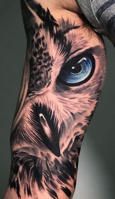 an owl with blue eyes is shown on the left arm and leg, while it's in full color