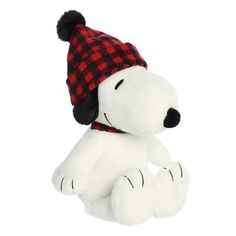 a white stuffed dog with a red and black hat on it's head sitting down