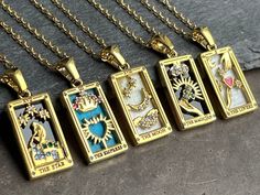 Tarot cards necklace enamel Mystical gold plated stainless steel necklace with various tarot card pendants embellished with enamel and sparkling crystals. Each pendant bears the symbols of tarot cards including "The Magician", "The Star", "The Moon", "The Empress III" and "The Lovers". These cards have profound meanings and are often used for spiritual and divinatory purposes. Simply select the desired chain as a variant. The magician: The magician symbolizes manifestation, creativity and is said to have the ability to turn dreams into reality. Of course, this is only understood symbolically. The Star: The star represents hope, inspiration and spiritual guidance. It reminds us to pursue our goals and believe in our dreams. The Moon: The Moon represents intuition, secrets and emotions. It e Cards Necklace, Hope Inspiration, Necklace Ideas, The Lovers, The Empress, Spiritual Gifts, Gold Enamel, Steel Necklace, Sparkling Crystal