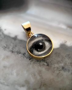 Lover's Eye pendant with an oil painting encased in gold plate over sterling with a quartz crystal cabochon which gives a magical magnifying effect, measuring 1/2" in diameter; 18" 16k gold over brass chain included. THE HISTORY: Lover's Eyes were a jewelry trend c.1785-1830 of brooches set with tiny watercolor portraits on ivory. Since they were cropped to eyes, they were in many ways more direct and intimate than traditional miniature portraits; but also because they were just eyes, they were Mystical 14k Gold Jewelry Gift, Mystical 14k Gold Jewelry, Mystical Yellow Gold Jewelry For Gift, Mystical Engraved Gold Jewelry, Mystical Gold Jewelry For Anniversary, Gold Mystical Jewelry For Anniversary, Spiritual 14k Gold Keepsake Jewelry, Spiritual Gold Cabochon Necklace, Gold Spiritual Necklace With Cabochon