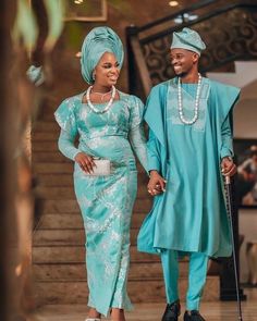 a man and woman dressed in traditional african attire