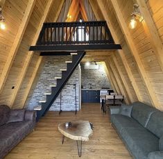 a loft with two couches and a coffee table in the middle of the room