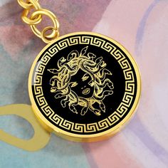 "This Medusa Keychain Is the Perfect Gift Whether for Yourself or a Loved One.  Explore all our Inspirational jewelry here: https://www.etsy.com/in-en/shop/SymbolicPresent?ref=seller-platform-mcnav&section_id=31033166 ➜ Our jewelry is made of high-quality surgical steel with a shatterproof liquid glass coating and an 18k gold finish option. ➜ Engrave onto the back of the Medusa Keyring your loved one's name, your wedding date, an anniversary, or anything else you want to remember and keep you cl Gold Metal Keychain Perfect For Gifts, Gold Metal Keychain For Gift, Medusa Accessories, Luxury Mythological Pendant Necklace, Versace La Medusa Bag, Medusa Pendant, Versace Greek Key Ring, Medusa Head, Glass Coating