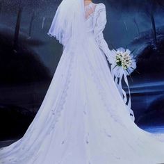 a woman in a white wedding dress and veil