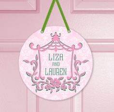 a pink door hanger with the words liza and lauren on it