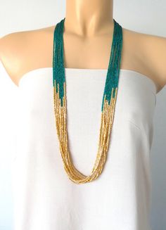 "Peacock green and light gold long boho necklace, seed bead necklace, beaded necklace, beaded multistrand necklace,green necklace,bridesmaids We can make this necklace in any colors! It has 8 strands. Matching earrings sold here https://www.etsy.com/listing/218792281/light-gold-beaded-earrings-gold Size shown in pictures is 33\". Please read specifications on SIZES below: ❤ SIZES This item comes in several sizes, kindly choose at checkout. The easiest way to find out which length suits you best Green Beaded Chain For Wedding, Green Multi-strand Necklace With Tiny Beads, Green Multi-strand Beaded Jewelry, Bohemian Green Beads For Wedding, Green Multi-strand Jewelry With Tiny Beads, Green Wedding Necklaces With Colorful Beads, Elegant Green Beaded Necklaces With Gold Beads, Elegant Green Beaded Necklace With Gold Beads, Maroon Necklace