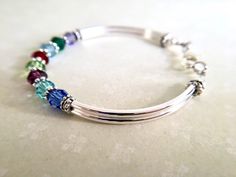 Mothers and grandmothers would love to receive one of these! It represents the birth of each of her children/grandchildren that she holds dear to her heart. Perfect Mother's Day, birthday or just because gift! This bangle type bracelet fits very comfortably on the wrist and works best with 6-10 Birthstones. If fewer or more Birthstones are needed I will need to slightly modify the design, but rest assured, it'll be lovely and appreciated by the recipient. It's made with 6mm round Swarovski Cryst Personalized Bracelets For Her, Mother's Day Jewelry, Mothers Bracelet, Birthstone Bracelet, Personalized Bracelet, Jewelry Bridesmaid, Just Because Gifts, Birthstone Bracelets, Personalized Bracelets