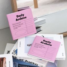 several books stacked on top of each other in front of a window with the words daily archive printed on them