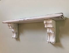 an old wooden shelf with white paint on it