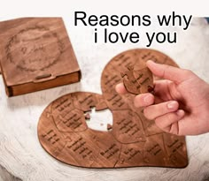 someone is holding a heart shaped puzzle in front of a box that says, reason why i love you