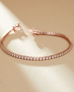 Adorn your wrist with this luxurious Rose Gold Tennis Bracelet, perfect for everyday elegance or special occasions. Crafted from high-quality 14k rose gold, this stunning bracelet features 3.00 carats of sparkling lab grown diamonds, making it a truly dazzling piece. Its timeless and sophisticated design ensures it will complement any outfit, whether casual or formal. Details: - Material: 14k Rose Gold - Weight: 7.2 grams of gold - Diamond Carat Weight: 3.00 carats total - Clasp: Secure Box Clas Luxury Rose Gold Tennis Bracelet With Prong Setting, Luxury Rose Gold Bracelets With Single Diamond, Rose Gold Tennis Bracelet, Formal Gold Bracelet, Rose Gold Diamond Bracelet, Gold Tennis Bracelet, Everyday Elegance, Diamond Tennis Bracelet, Wedding Jewelry Bracelets