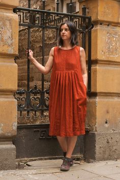 ABOUT THE GARMENT: This is a long red brick color linen loose fitted dress with pleated top and skirt. It is sleeveless with two big comfortable side pockets, oval neck.  It is made of 100% pure, high quality linen.  The garment is handmade by Mirella Bratova Design.  It's comfortable and practical for every day use, but it is perfect also for special occasions.  It's great for the summer.  Each piece is individually cut, sewn and pre-washed. DETAILS: - 100 % pure high quality linen - oval neck Sleeveless Pleated Dress With Box Pleat For Summer, Sleeveless Box Pleat Pleated Dress For Summer, Casual Pleated Orange Dress, Casual Orange Pleated Dress, Casual Sleeveless Dress With Pleated Bodice, Red Sleeveless Dress With Pockets, Casual Sleeveless Dress With Pleated Hem, Casual Dress With Pleated Waist, Casual Pleated Midi Dress