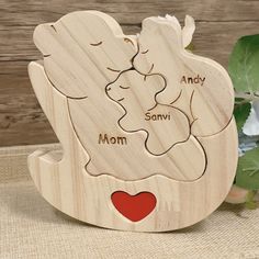 a wooden figurine with the name and image of a baby's mom