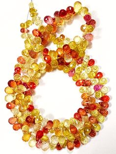 multicolored glass beads are arranged on a white surface