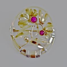 An Antique delicate Art Nouveau brooch pin with bezeled antique cut natural rubies. Gold wires form an oval frame attached together with white gold fashioned clips. Adding to the vibrance of the brooch are accents of rose and white gold. Free flowing gold wire tendrils fuse a vigorous spray of leaves and orchids.   The brooch is 18K gold with an eagle stamp on the pin stem. The clasp is a type of push pull method of closing. The clasp was first seen in use in the early 1890s on European jeweller Oval Yellow Gold Brooches With Gemstone, Art Deco Oval Brooch For Anniversary, Heirloom Style Oval Filigree Brooch, Heirloom Filigree Oval Brooch, Heirloom Oval Filigree Brooch, Yellow Gold Oval Brooch For Wedding, Art Deco Oval Wedding Brooches, Art Deco Oval Brooch Jewelry, Vintage White Gold Oval Brooches