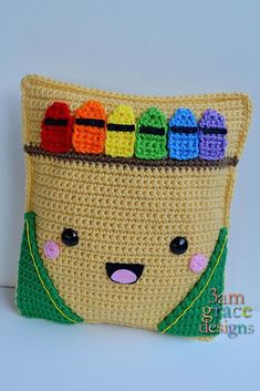 a crocheted bag with a face made out of crochet and colored crayons