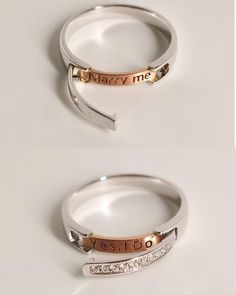 two wedding rings with names on them sitting next to each other in front of a white background