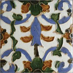 an intricately designed tile with blue and orange designs on it's sides,