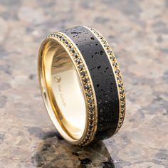 a black and gold wedding band with white diamonds