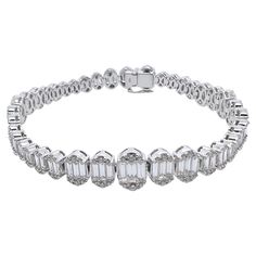 This diamond tennis bracelet is unique and an eye catcher! The baguettes are graduated in the design with the round brilliant diamonds on the outside shoulders. The contrast of the brilliant round diamonds against the crisp, white baguettes is remarkable and will grasp everyone's attention! The mounting is made in 18k white gold and is perfect for any occasion - smart casual to formal events! Diamonds: 6.49 cts, Baguette, Round Brilliant Metal: 18k White Gold Luxury Platinum Diamond Bracelet With Baguette Diamonds, Timeless Tennis Bracelet With Baguette Diamonds, Formal Diamond Baguette Bracelet, Luxury Diamond Tennis Bracelet With Baguette Cut, Luxury Diamond Tennis Bracelet Baguette Cut, Formal Baguette Diamond Bracelet With Accents, Diamond White Platinum Bracelet With Baguette Diamonds, Diamond White Baguette Cut Platinum Bracelet, Diamond Tennis Bracelet With Baguette Cut Accents