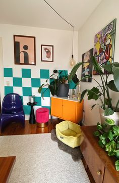 a living room filled with furniture and lots of plants