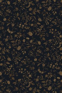 a black and gold wallpaper with flowers on it's side, in the dark