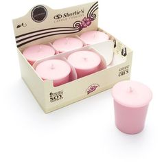 six pink candles in a box on a white background