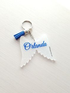 a white keychain with the word, ohana on it and an angel wing