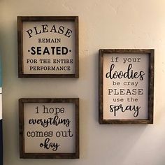 three framed signs are hanging on the wall